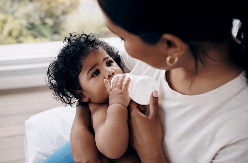 Mother holding her baby feeding a bottle.