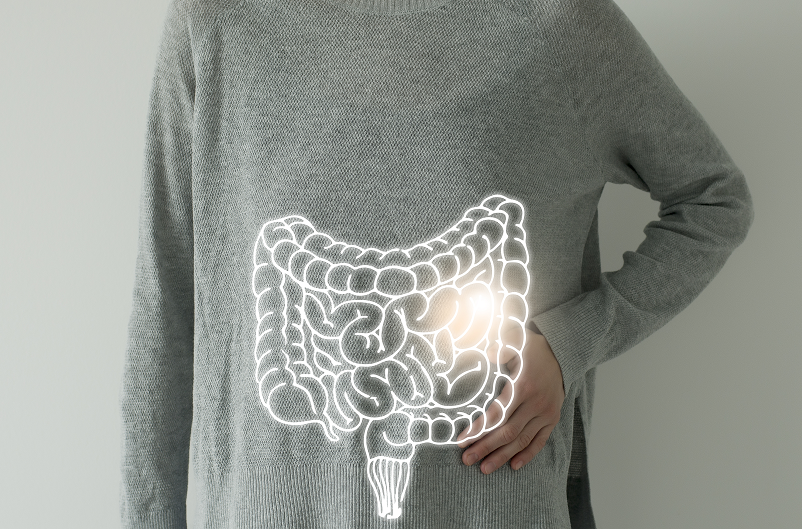 Woman in a gray sweater with a highlighted vector visualization of a colon.