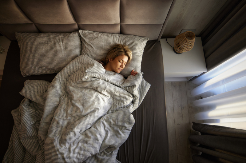 High angle view of relaxed woman sleeping in a bed.