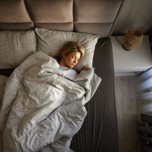 High angle view of relaxed woman sleeping in a bed.