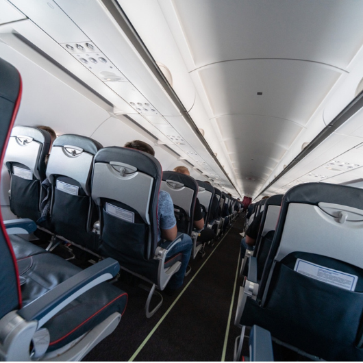 An interior shot of a commercial passenger airplane.