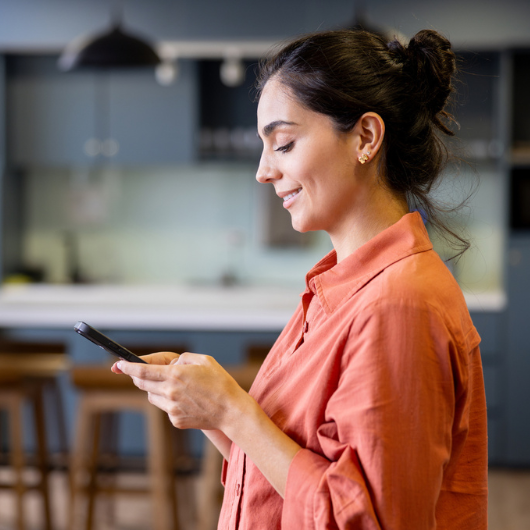 Beautiful Latin American businesswoman texting on her cell phone.