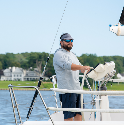 Rick Kolber captaining a boat out on the water.
