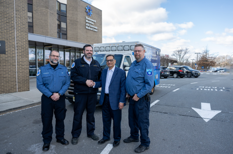Kash Saraiya and three EMS personnel stand outside JFK University Medical Center.