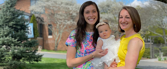 Jeanne Butare and her wife holding their baby