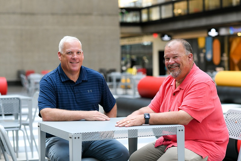 Vinnie and Ken Hager sitting at a table together