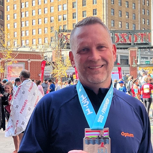 Gerald Branim smiling, with a medal around his neck, while at a race.