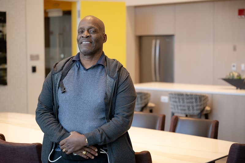 Darrin Wlikins smiling and standing.