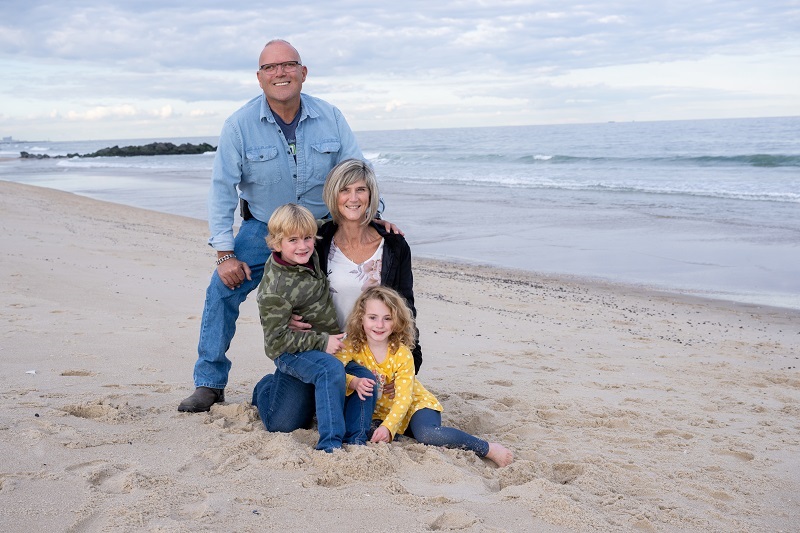 Dawn and her family at the beach smiling together.