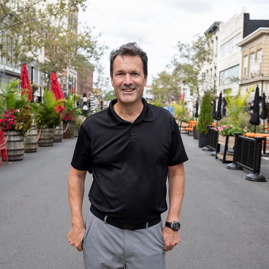 Don Heintz standing in the street in Red Bank smiling.