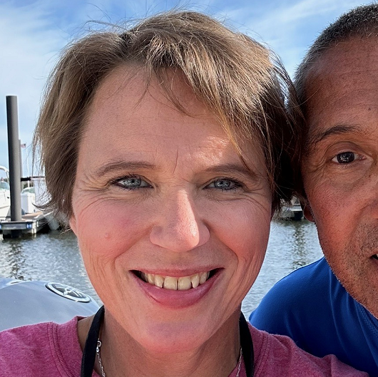 Emily Kmosko and her fiance smiling.