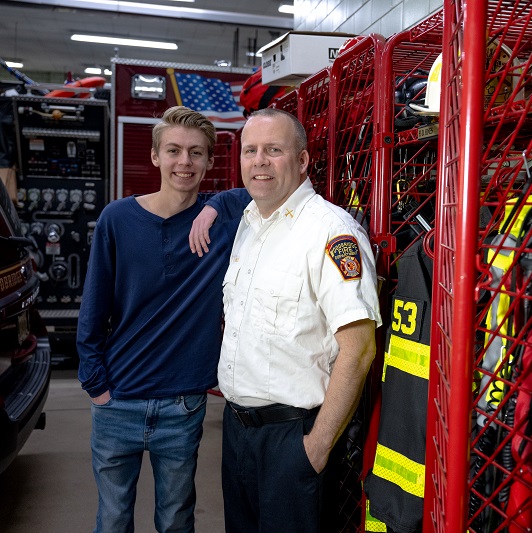 Teenager Mark and his father David inside the Woodbridge fire station.