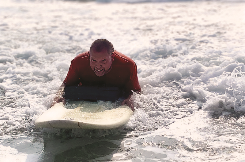 Mike O'Grady surfing at the beach.