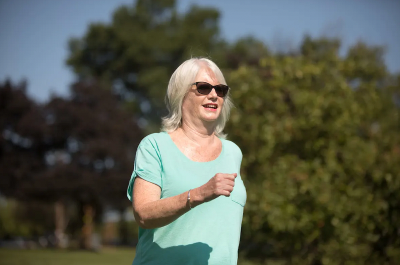 66-year-old Middlesex woman Mary Logan walks briskly outdoors.