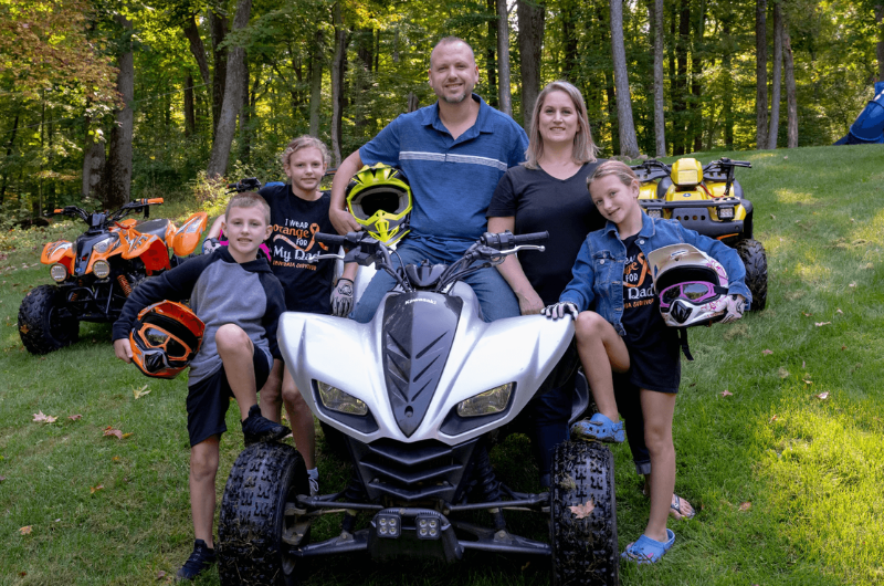 Adam Gourlay, of Fredon, New Jersey, stands next to his four-wheeler with his wife and three kids.