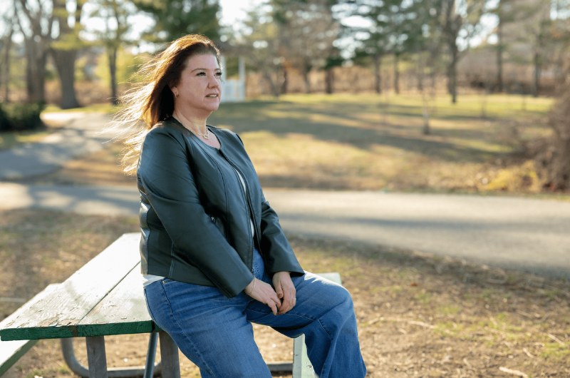53-year-old Andrea Loberbaum of Upper Saddle River, New Jersey, leans against a picnic table.