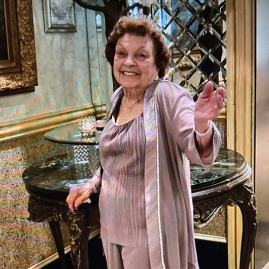 While dancing, 100-year-old Fannie Mutchko smiles at the camera.