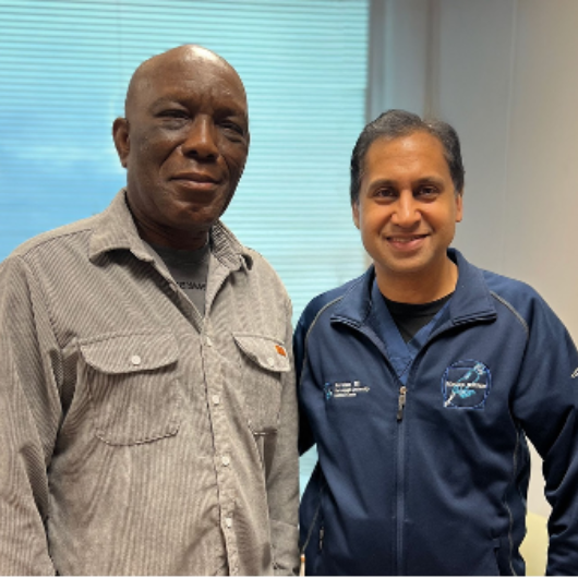 Dr. Daniel Seddoh, a retired corporate executive and professor from Ghana, stands next to Ravi Munver, M.D.