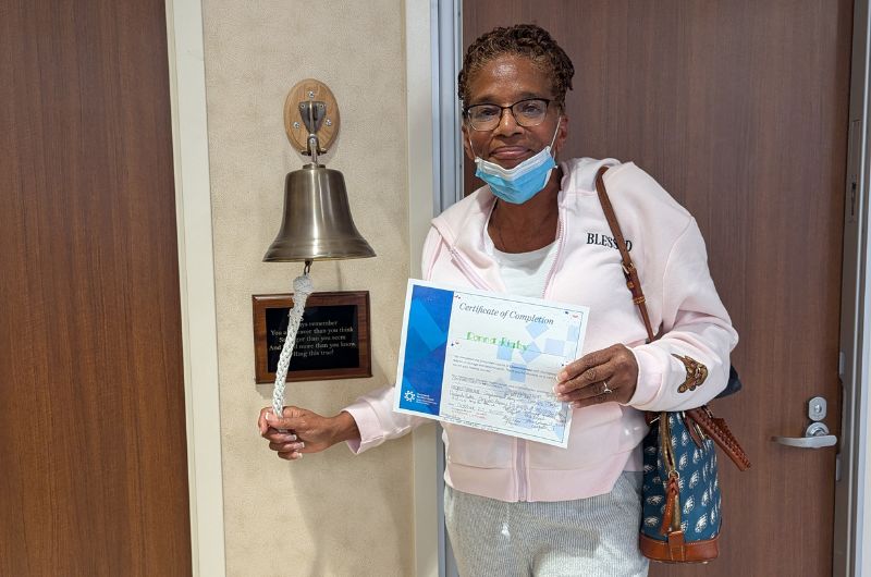 Lung cancer patient Donna Rigby rings the bell after her last cancer treatment.