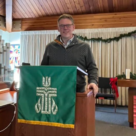 Image shows Pastor and Hackensack Meridian Health patient Todd Schumpert standing at the pulpit.