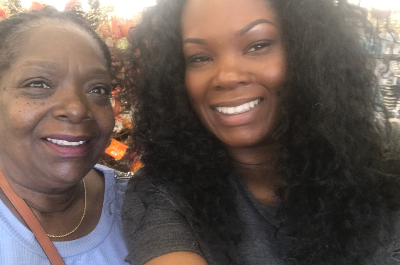 Curlean Phillips and her daughter, Chanda, smile at the camera.