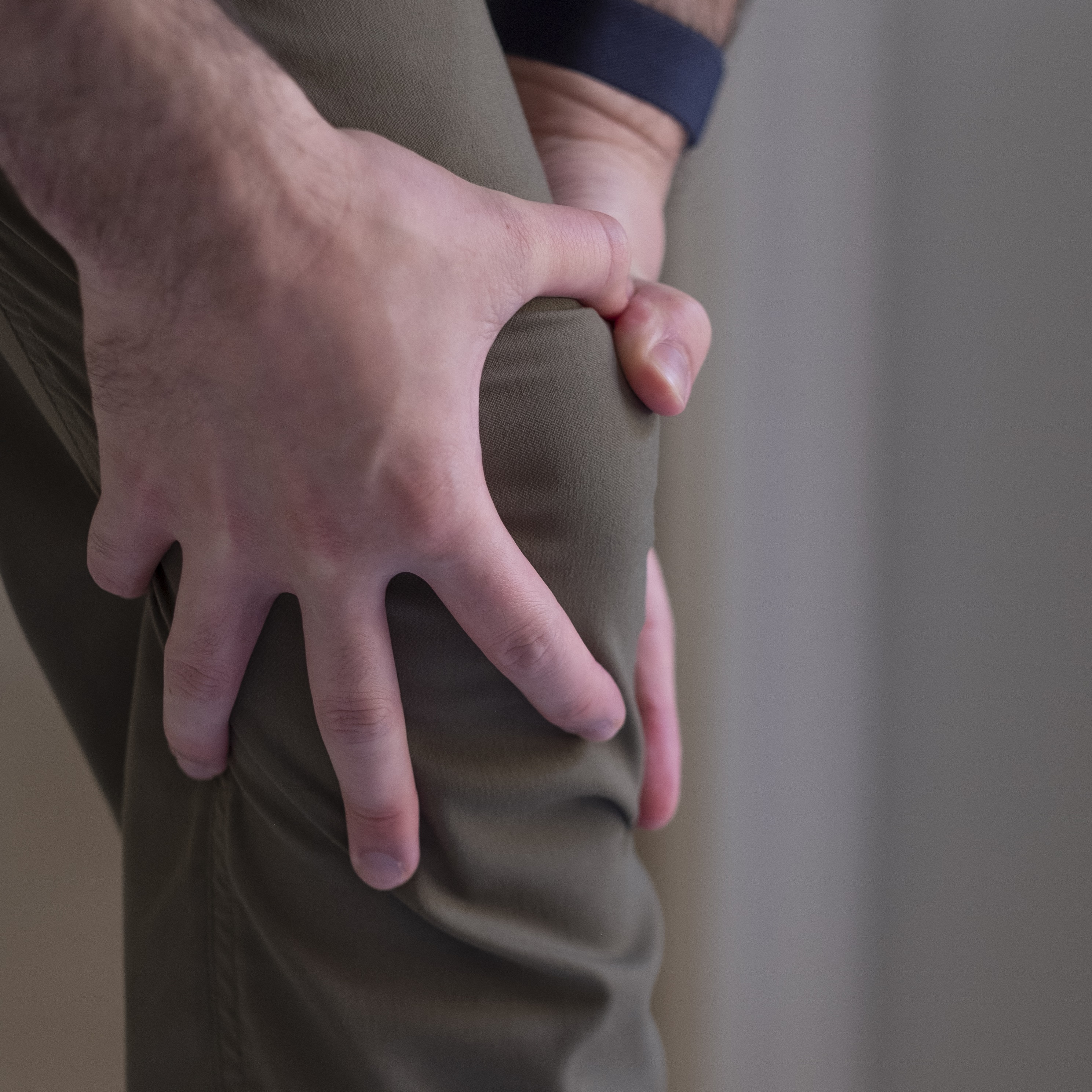 Person gripping knee