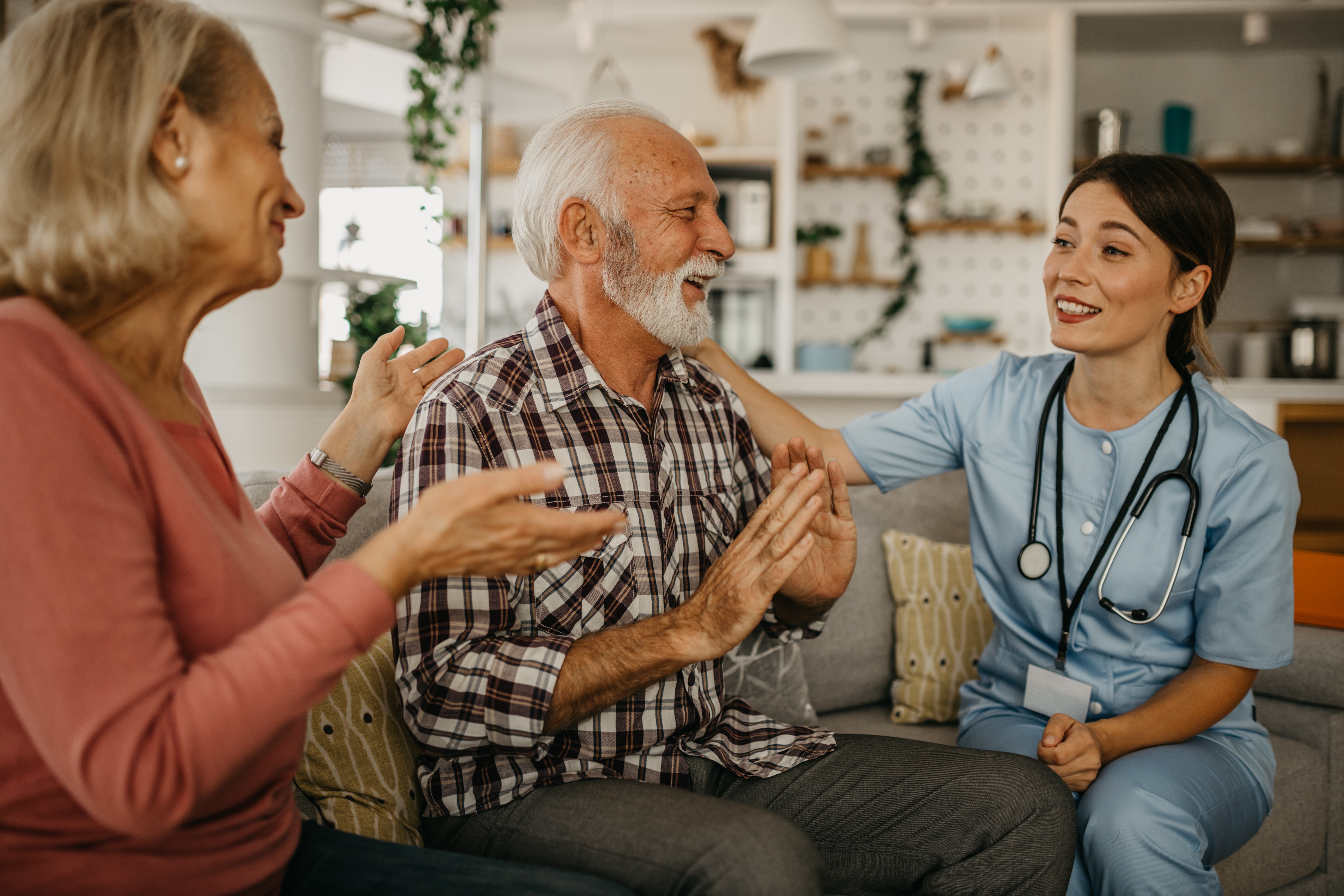 nurse with older couple in their home