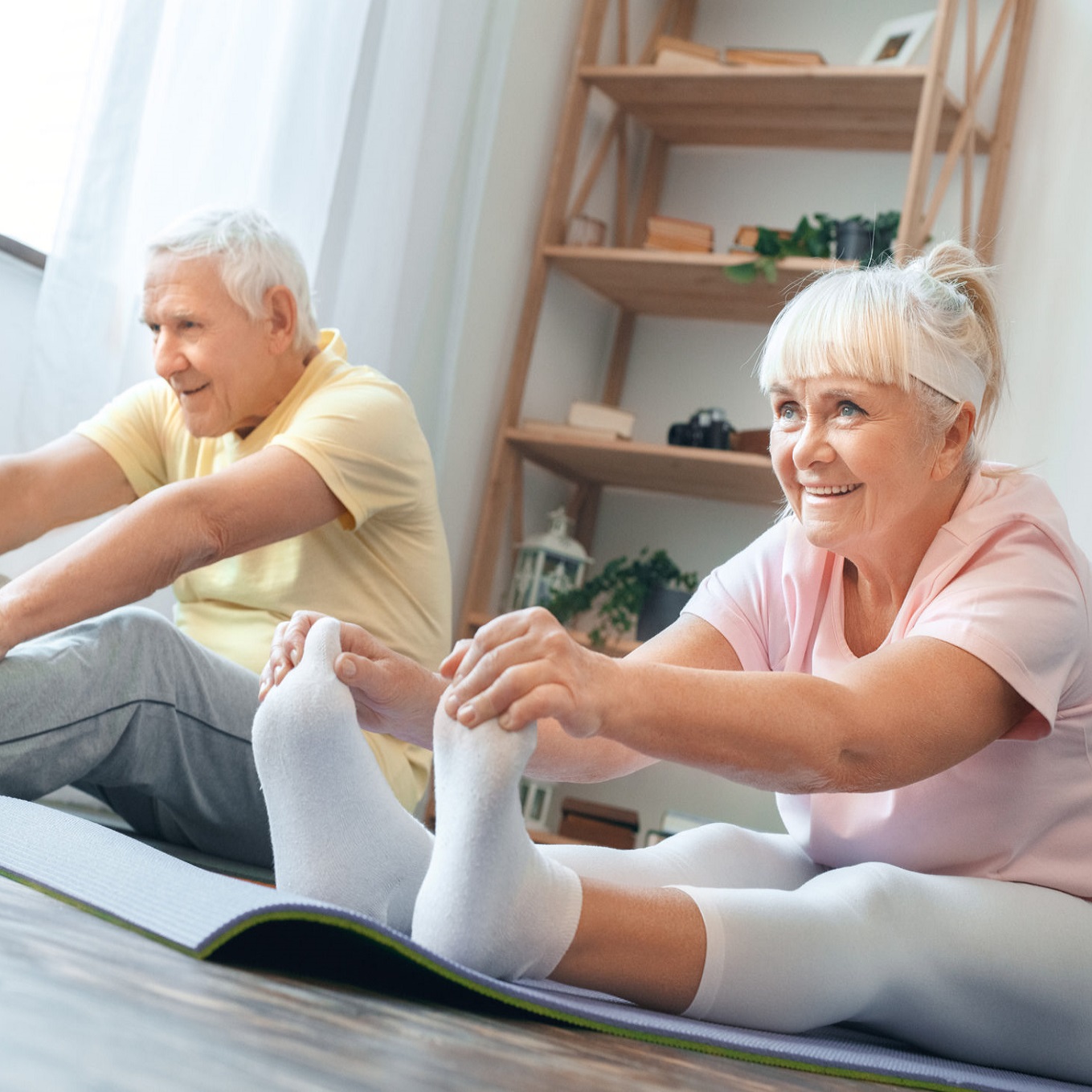 Two seniors stretching