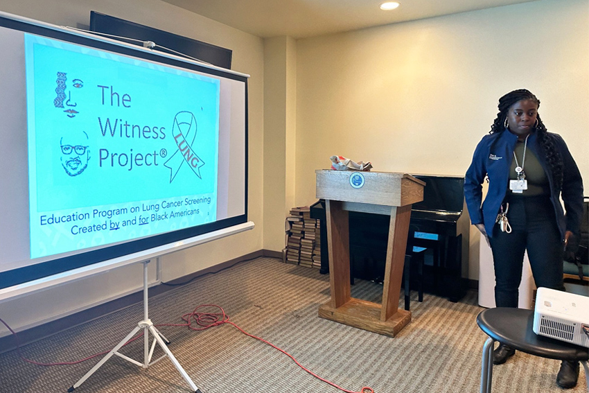 presenter standing in front of projector screen