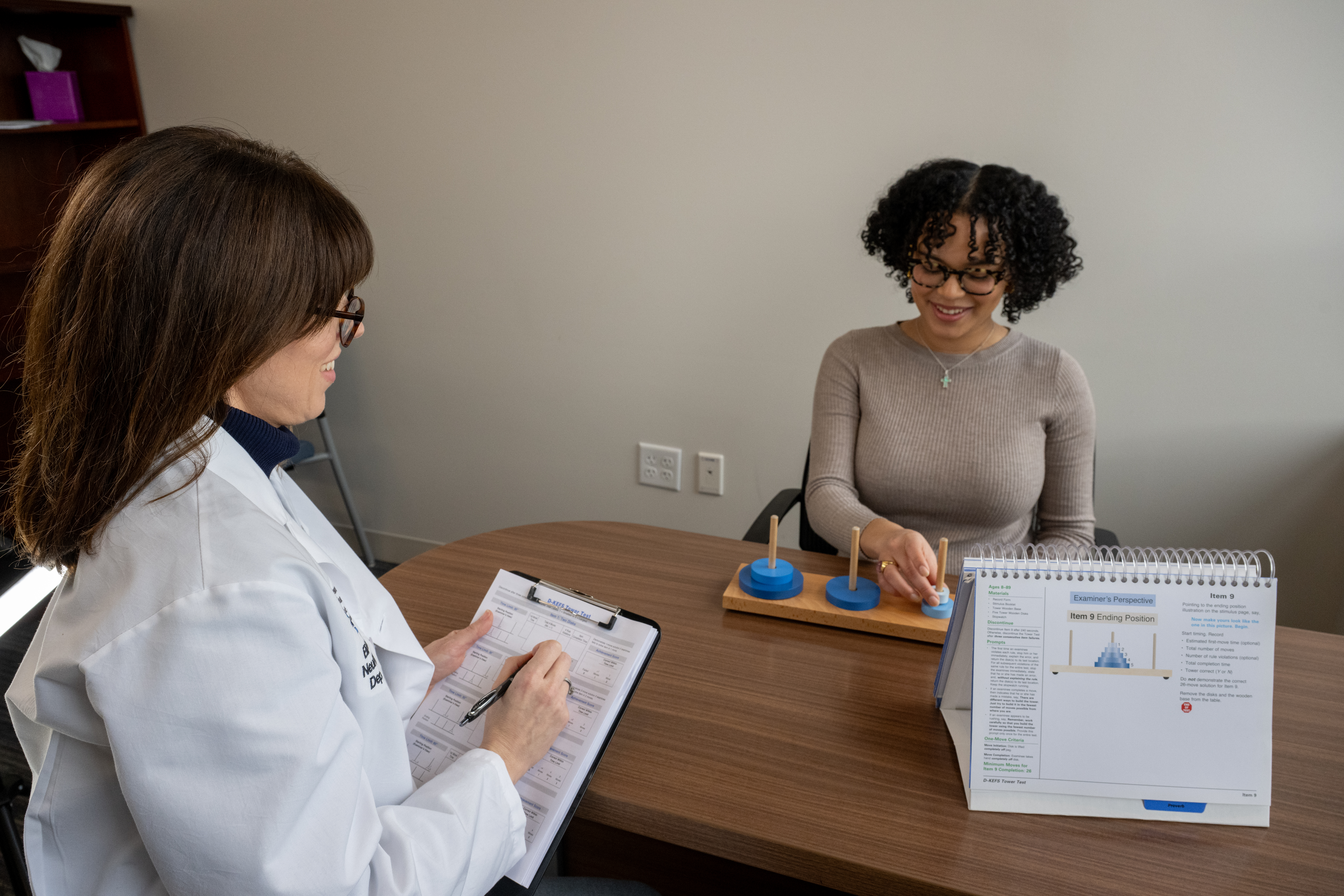 Woman taking neuro assessment with doctor