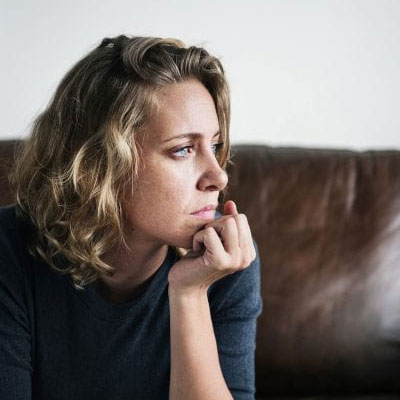 Woman thinking with hand on chin