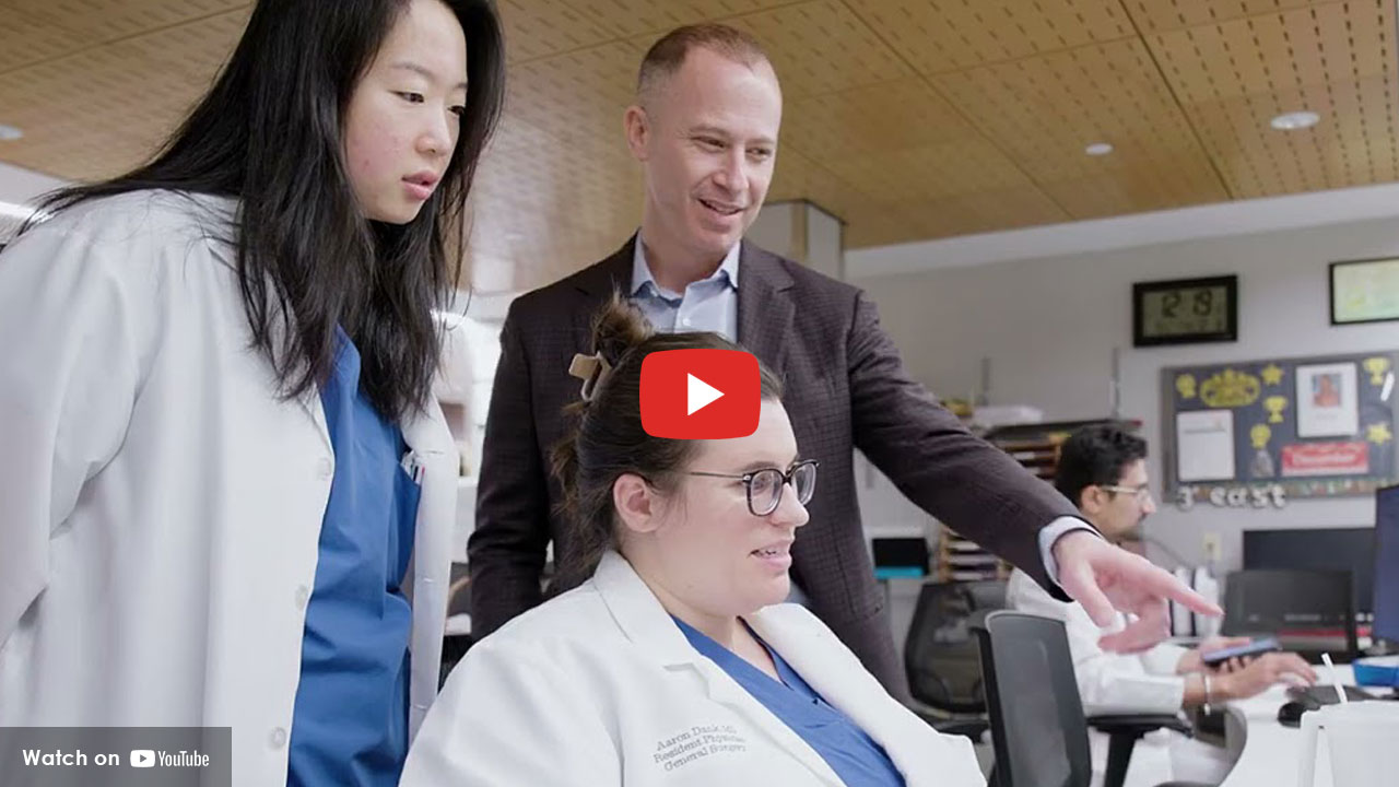 Doctors reviewing data on a computer screen