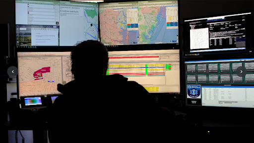 Hackensack Meridian Health dispatchers responding to 911 calls, screens showing maps and logistics