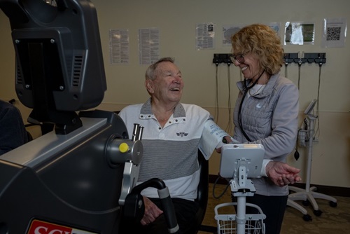 88-year-old Don Squier talking with his nurse.