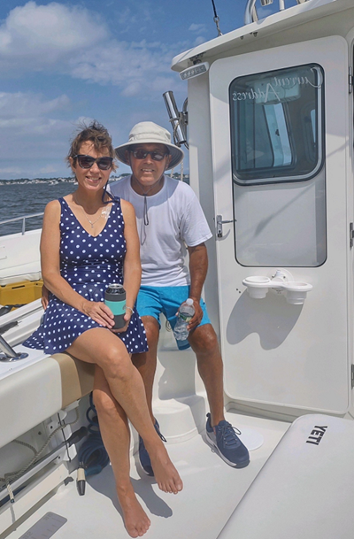 Emily Kmosko and her fiance on a boat smiling.
