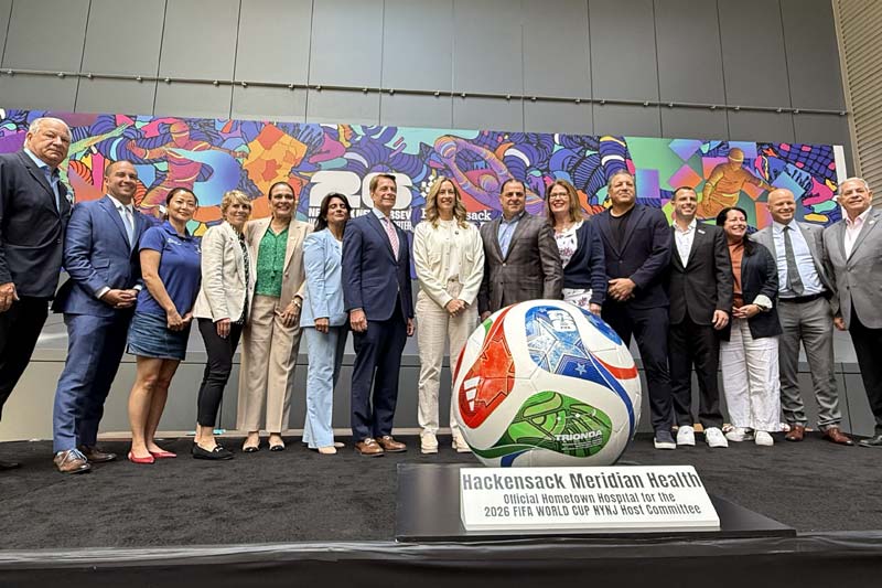 Group of people sanding in a single line for World Cup conference