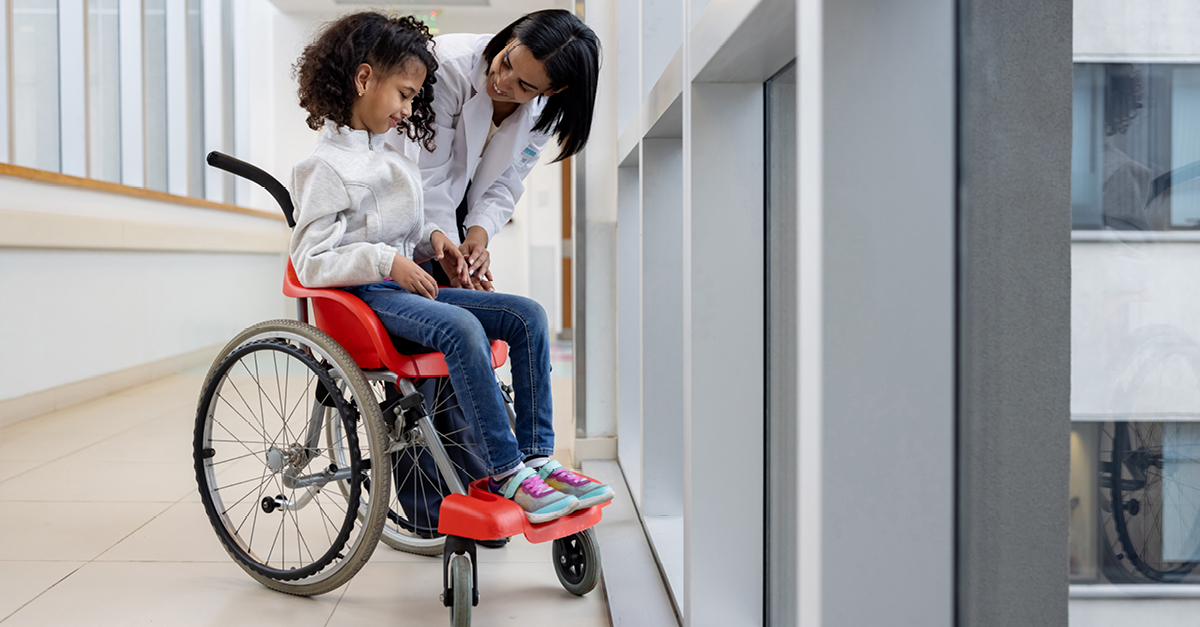 Pediatric patient in wheelchair with doctor