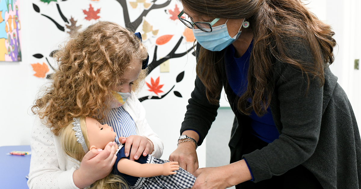 Doctor with pediatric patient and doll