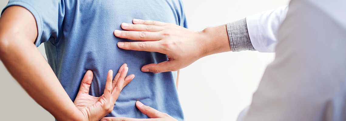 Patient having back examined by doctor